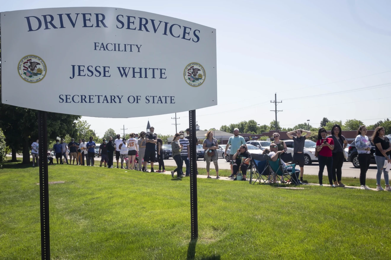 People wait in long lines to use the Secretary of State Driver Services facility on June 2, 2020, in Naperville, Ill. The digital driver’s license initiative could help reduce office wait times and lines at DMVs because the digital platform will allow users to make changes to their licenses and IDs remotely without having to make an in-person visit, the Secretary of State said.